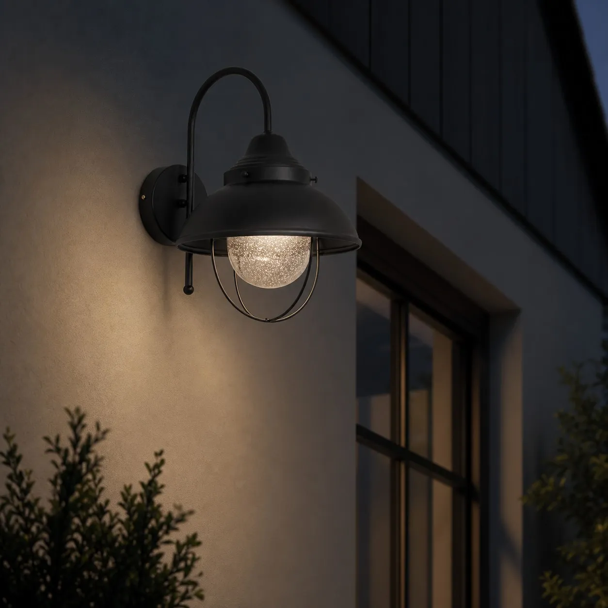 Black seeded-glass wall lamp creating a warm evening accent