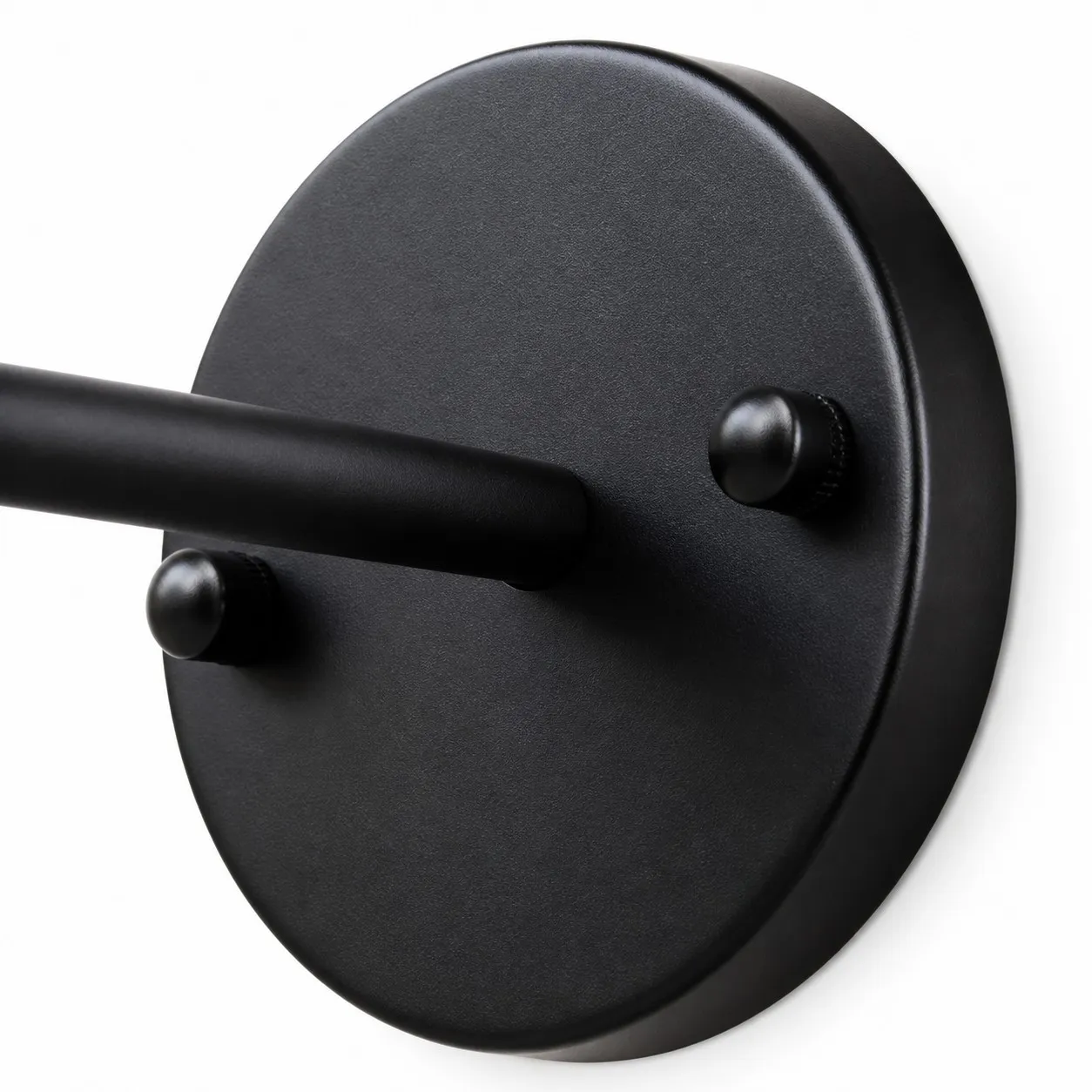 Close view of black round wall plate and arm connection