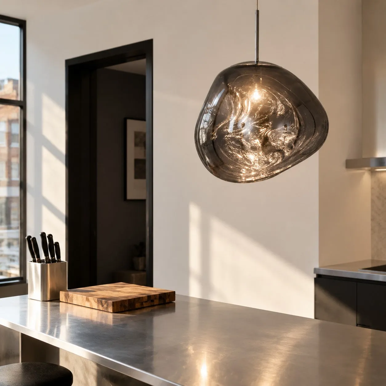 Suspension Molten Form gris fumé au-dessus d'un îlot de cuisine
